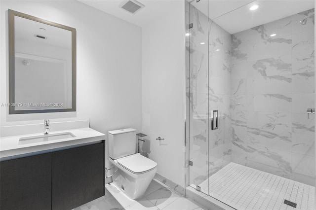 bathroom featuring a shower with door, vanity, and toilet