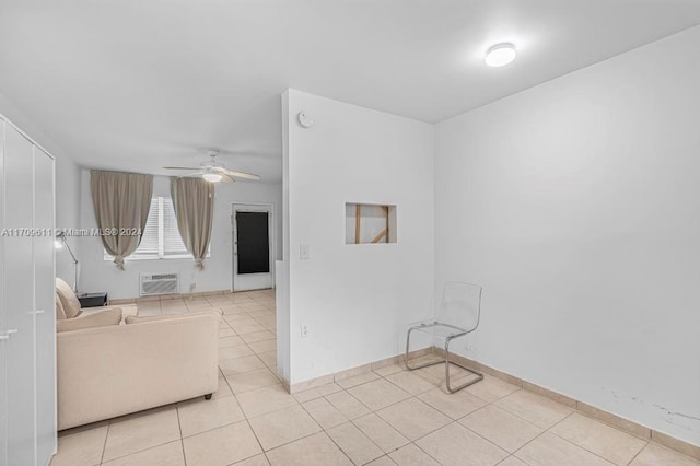 unfurnished room with a wall mounted air conditioner, ceiling fan, and light tile patterned floors