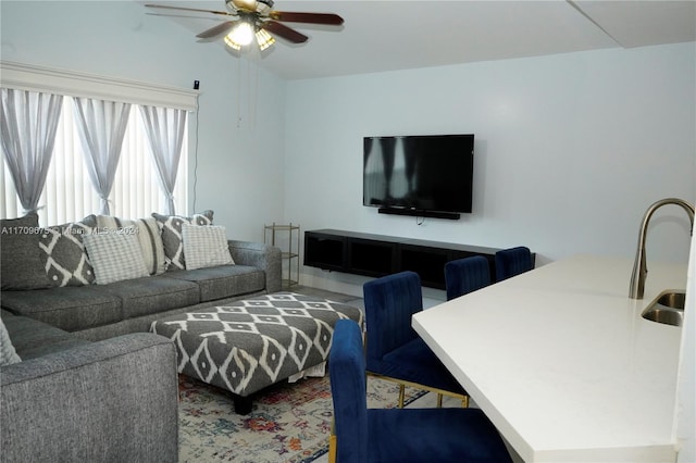 living room with ceiling fan and sink