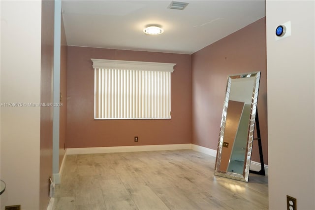 unfurnished room with light hardwood / wood-style floors