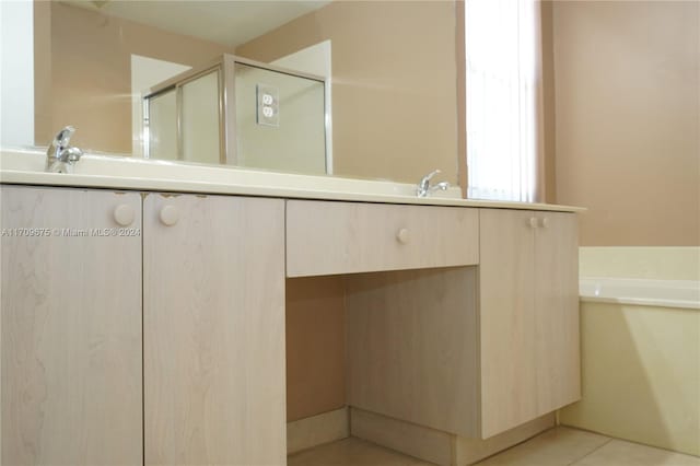 bathroom featuring tile patterned flooring and separate shower and tub