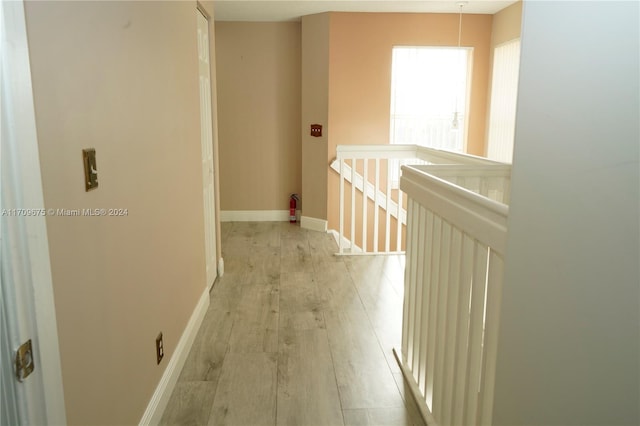 hallway with light hardwood / wood-style floors