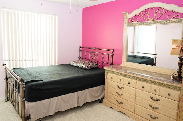 bedroom featuring light carpet