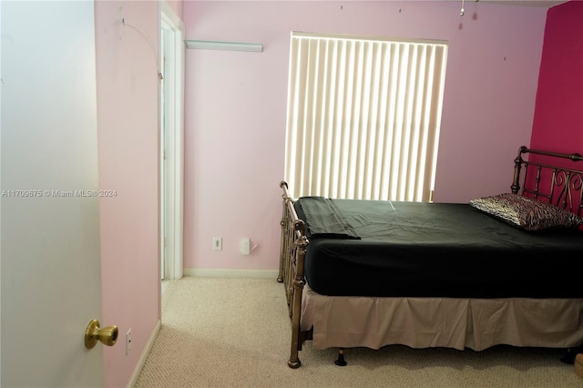 bedroom featuring light colored carpet