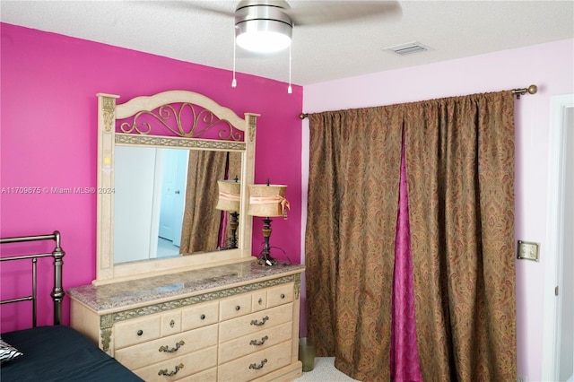 bedroom featuring a textured ceiling and ceiling fan