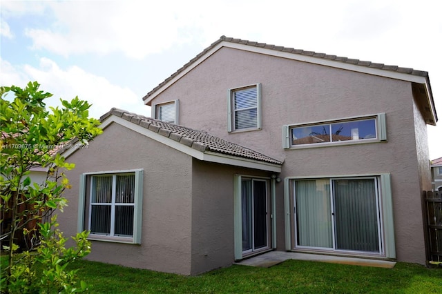 rear view of house with a lawn