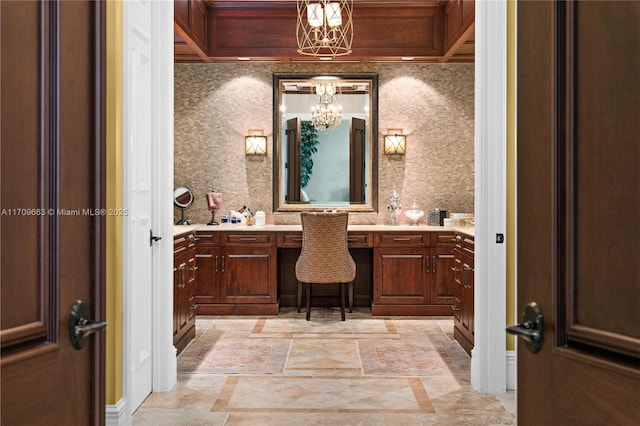 bathroom featuring vanity, tasteful backsplash, and a notable chandelier