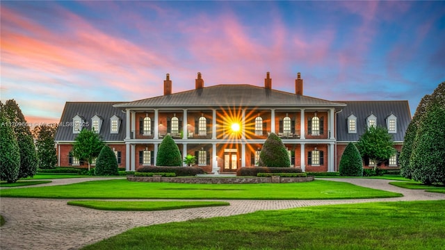 greek revival inspired property featuring a yard