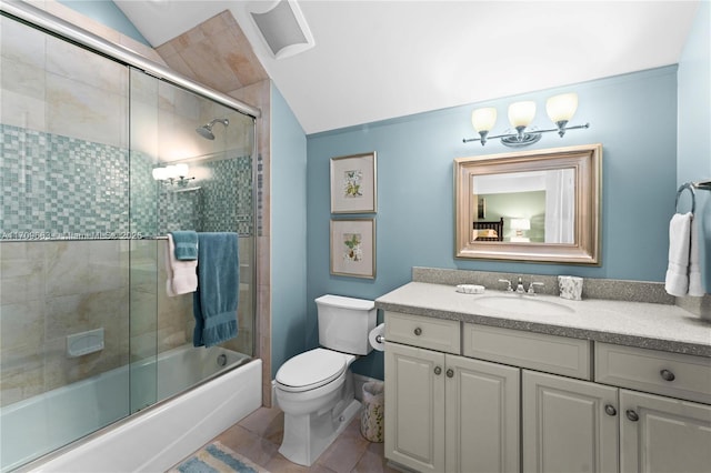 full bathroom featuring combined bath / shower with glass door, tile patterned floors, lofted ceiling, toilet, and vanity