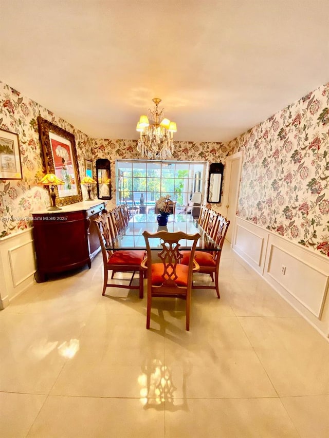 dining space featuring light tile patterned floors and an inviting chandelier