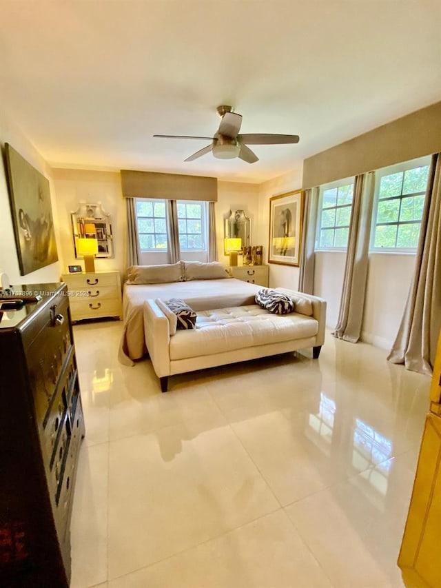 tiled bedroom featuring ceiling fan