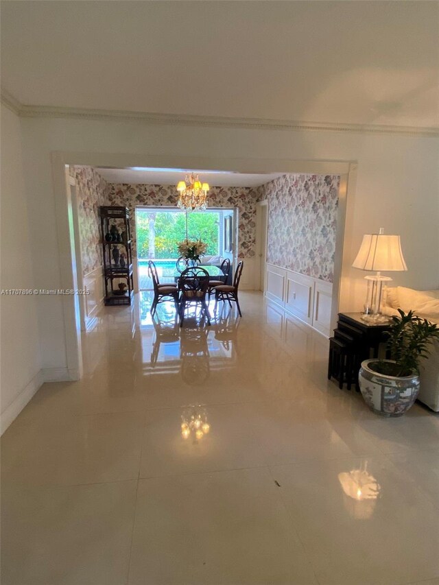 7521 SW 165th Ter, Palmetto Bay, FL 33157 - tiled dining space featuring crown molding, a chandelier, baseboards, a decorative wall, and wainscoting