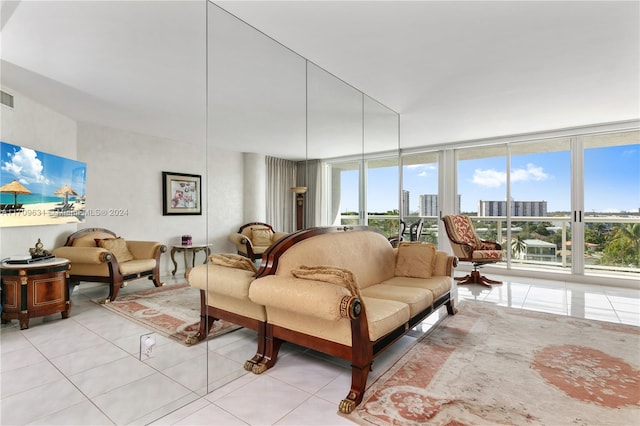 living room with expansive windows and light tile patterned flooring