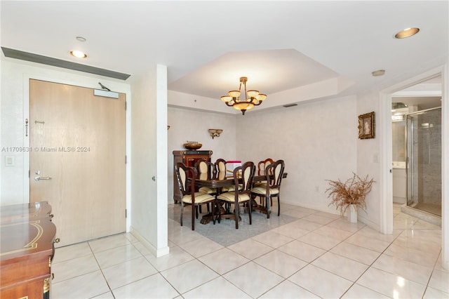 dining room with light tile patterned floors and an inviting chandelier