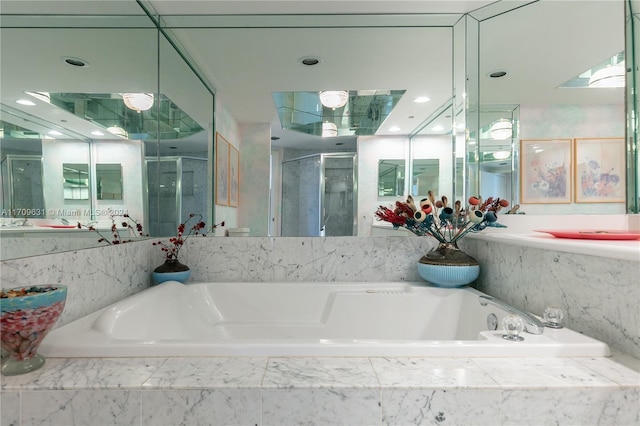 bathroom featuring separate shower and tub