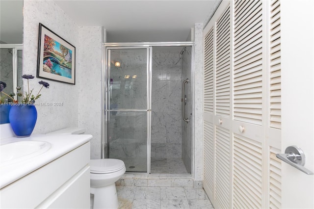 bathroom with an enclosed shower, vanity, and toilet