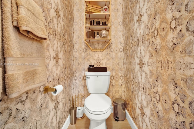 bathroom featuring wood-type flooring and toilet