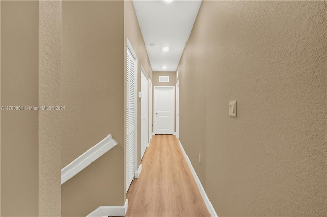 corridor with light hardwood / wood-style flooring