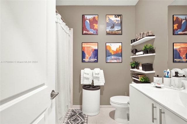 bathroom with tile patterned floors, walk in shower, vanity, and toilet