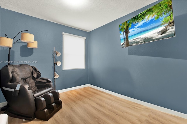 living area featuring hardwood / wood-style floors and a textured ceiling