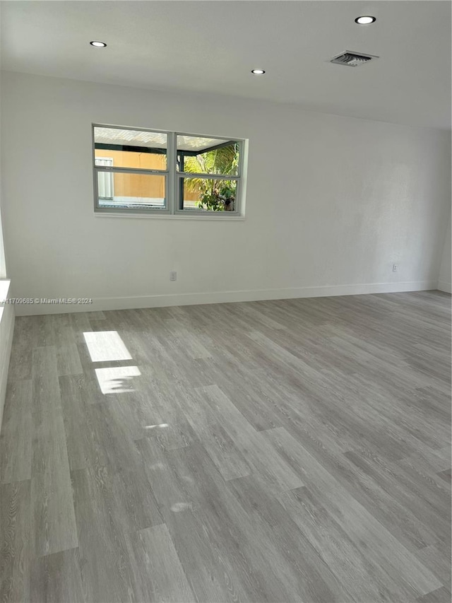 unfurnished room with light hardwood / wood-style floors