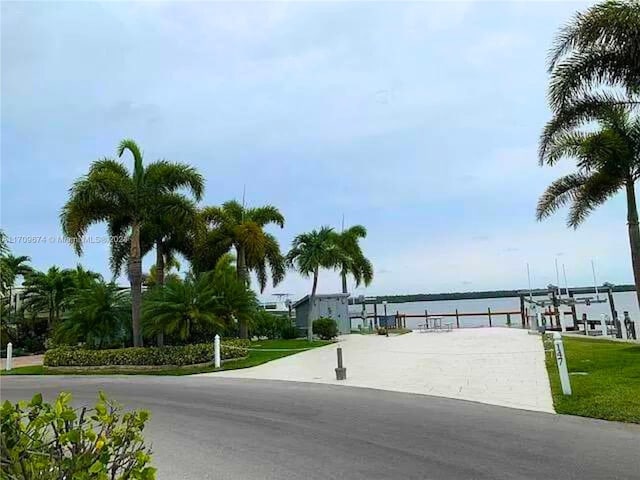 view of home's community with a yard and a water view