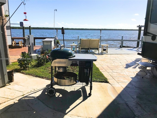 view of patio featuring a boat dock and a water view