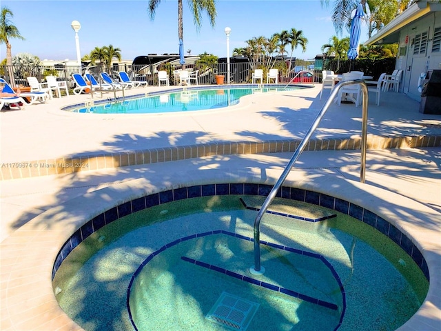 view of pool featuring a patio area and a hot tub