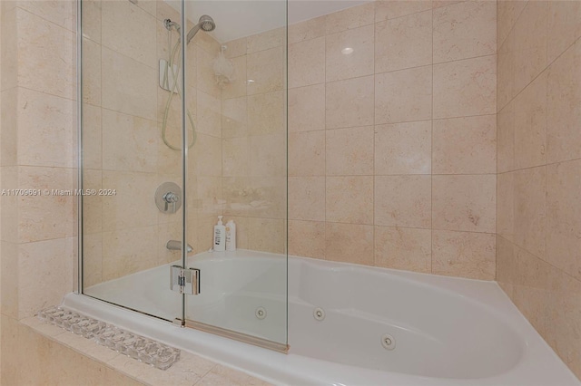 bathroom with shower / bath combination with glass door