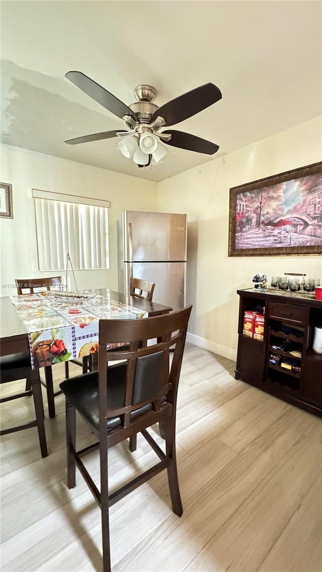 dining room featuring light hardwood / wood-style floors and ceiling fan