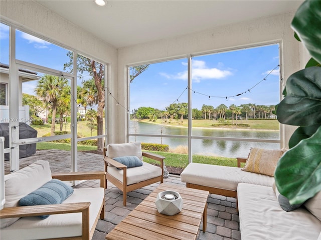 sunroom / solarium with a water view