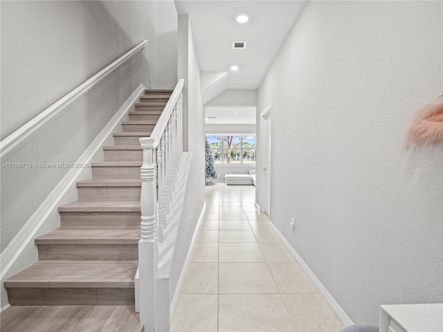 stairway with tile patterned flooring