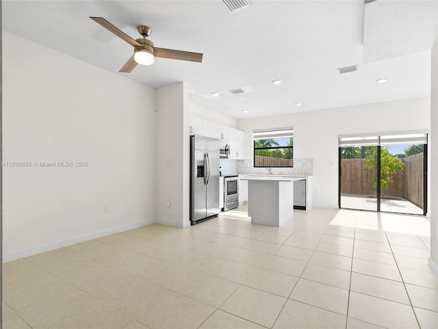 interior space featuring ceiling fan, sink, and light tile patterned floors