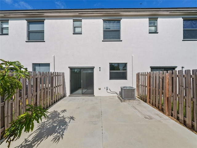 rear view of property featuring a patio area and central air condition unit