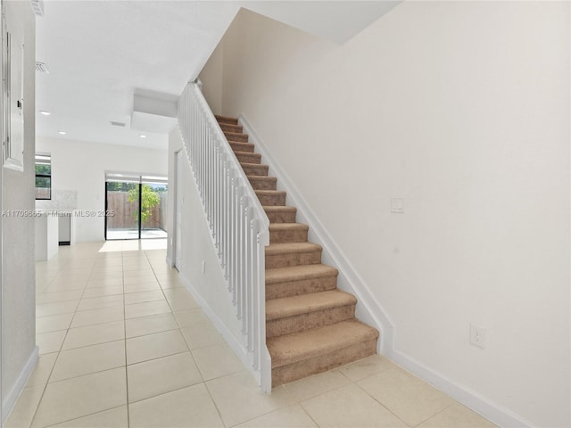 stairway featuring tile patterned floors