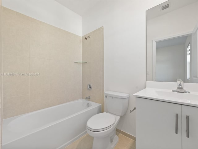 full bathroom with tile patterned floors, tiled shower / bath combo, toilet, and vanity