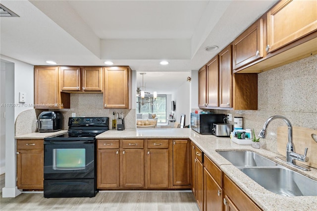 kitchen with decorative backsplash, sink, pendant lighting, light hardwood / wood-style flooring, and black electric range