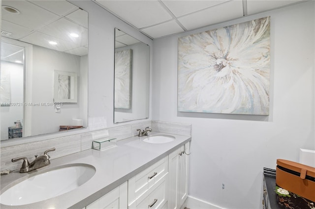 bathroom featuring vanity and a drop ceiling