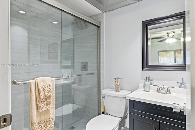 bathroom featuring vanity, toilet, and a shower with shower door