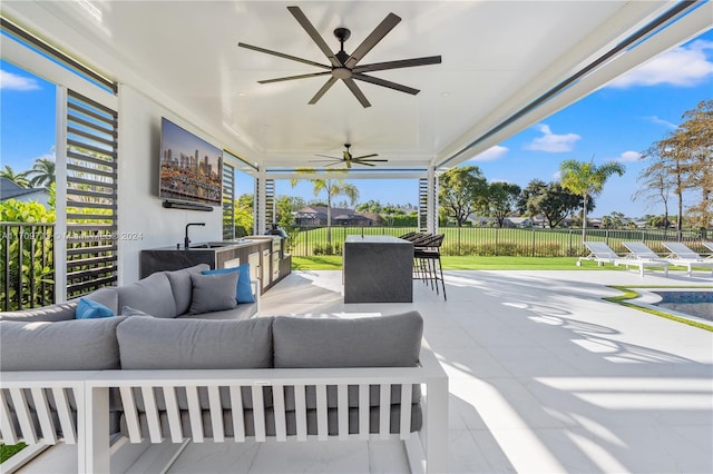 view of patio / terrace with ceiling fan, an outdoor hangout area, and an outdoor bar