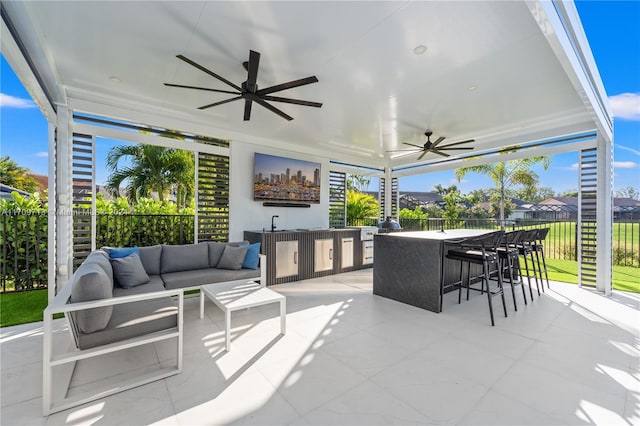 view of patio / terrace with outdoor lounge area and a bar