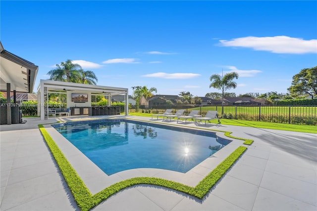 view of pool featuring a patio, an outdoor bar, and ceiling fan