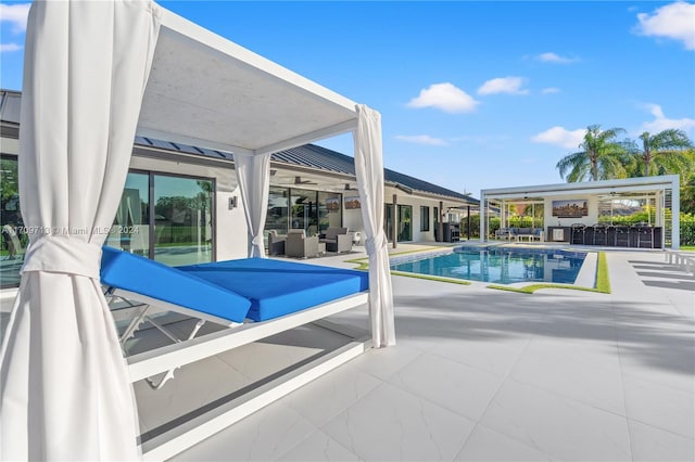 view of swimming pool with ceiling fan, a patio area, and an outdoor hangout area