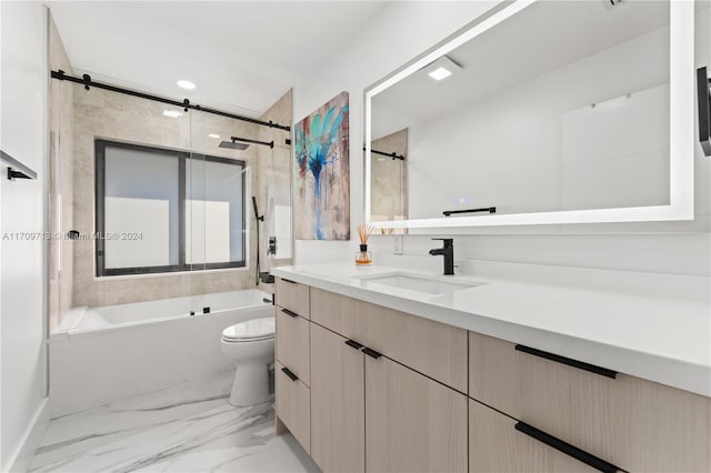 full bathroom with vanity, tiled shower / bath combo, and toilet