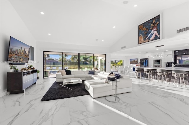 living room with high vaulted ceiling