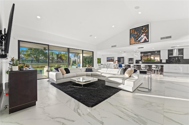 living room featuring high vaulted ceiling