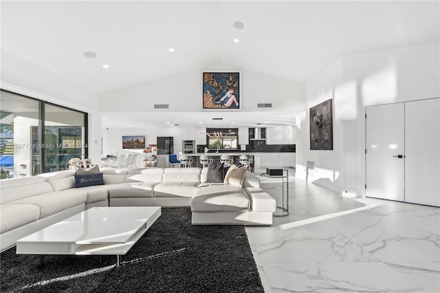 living room featuring high vaulted ceiling