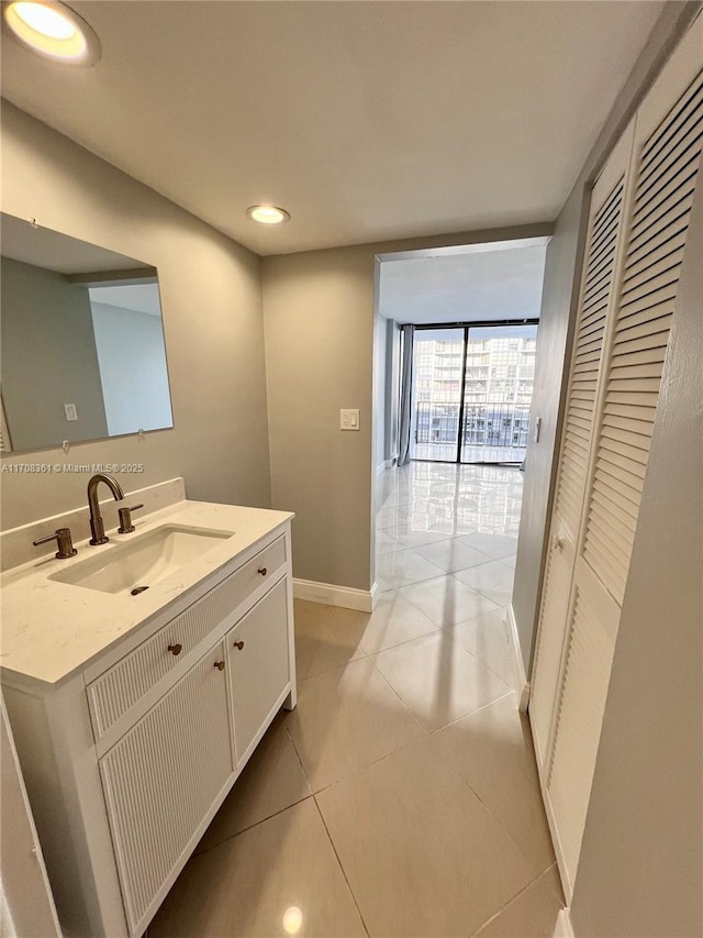 bathroom featuring tile patterned flooring, vanity, and floor to ceiling windows