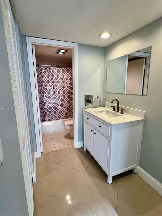 bathroom featuring tile patterned flooring, vanity, and toilet