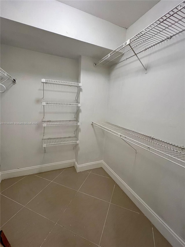 spacious closet with tile patterned floors